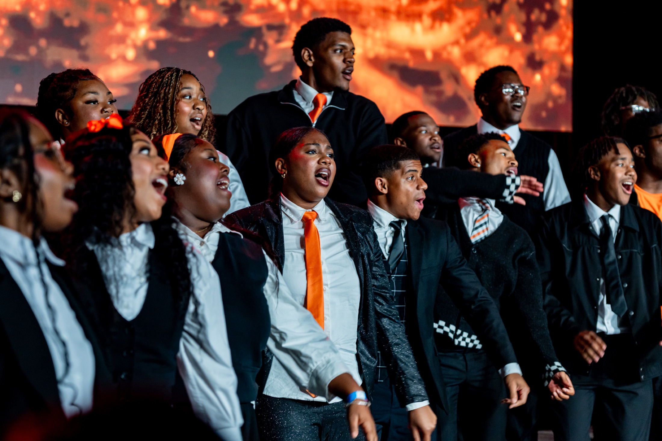 Ablaze Youth Choir performing on stage under fire effects